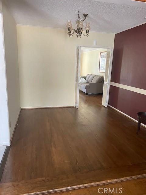 602 N Griffith Park Dr, Burbank, CA 91506 - unfurnished dining area with dark wood-style flooring, a chandelier, and a textured ceiling