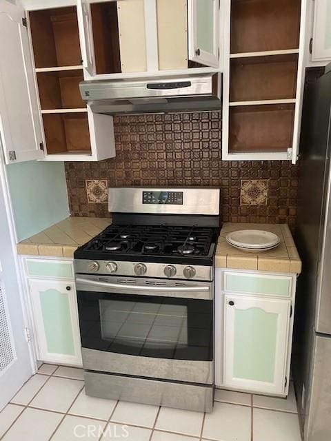 602 N Griffith Park Dr, Burbank, CA 91506 - kitchen featuring stainless steel appliances, open shelves, tile counters, white cabinets, and ventilation hood