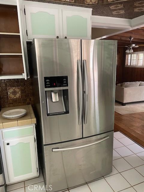 602 N Griffith Park Dr, Burbank, CA 91506 - kitchen featuring stainless steel refrigerator with ice dispenser, white cabinets, a ceiling fan, tile countertops, and light tile patterned floors
