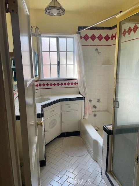 602 N Griffith Park Dr, Burbank, CA 91506 - bathroom with vanity, bathing tub / shower combination, and tasteful backsplash