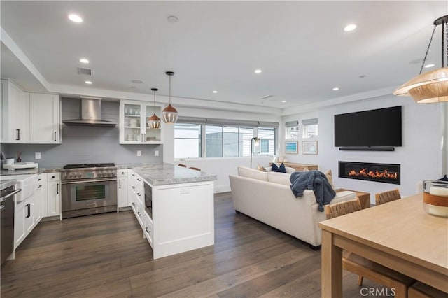 7141/2 Iris Ave, Newport Beach, CA 92625 - kitchen with high end range, wall chimney range hood, white cabinets, dark wood-style floors, and recessed lighting