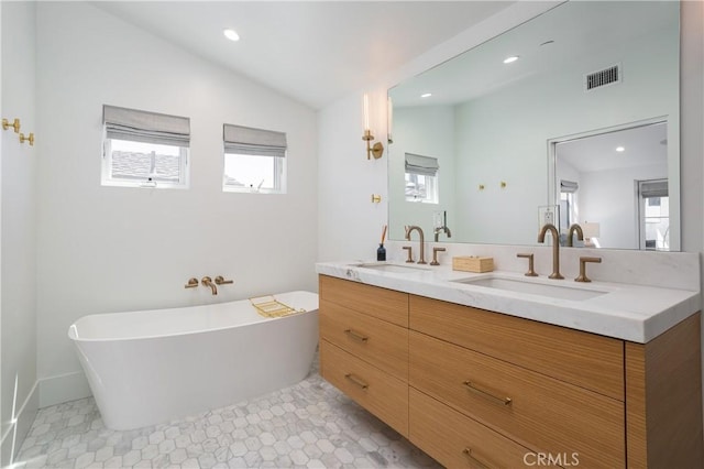 7141/2 Iris Ave, Newport Beach, CA 92625 - bathroom featuring double vanity, a freestanding bath, lofted ceiling, and recessed lighting