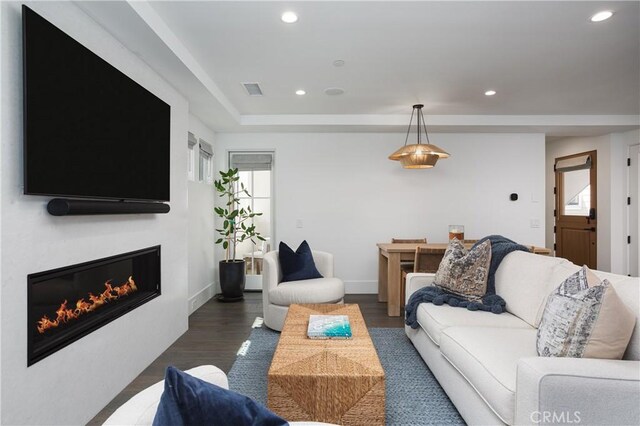 7141/2 Iris Ave, Newport Beach, CA 92625 - living area featuring recessed lighting, dark wood-type flooring, a glass covered fireplace, and a raised ceiling