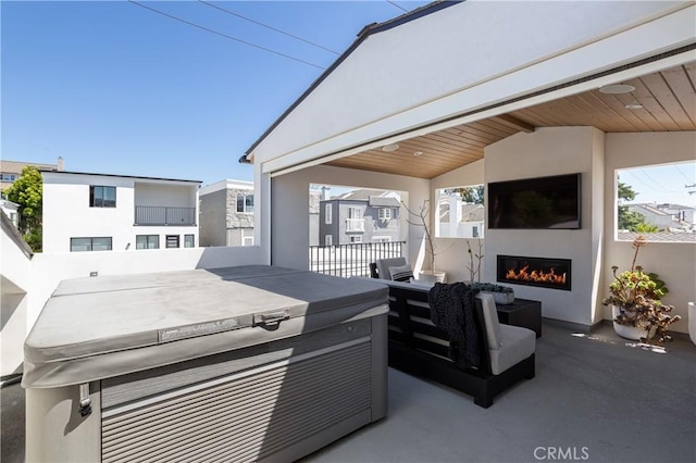 7141/2 Iris Ave, Newport Beach, CA 92625 - view of patio featuring a hot tub and an outdoor living space with a fireplace
