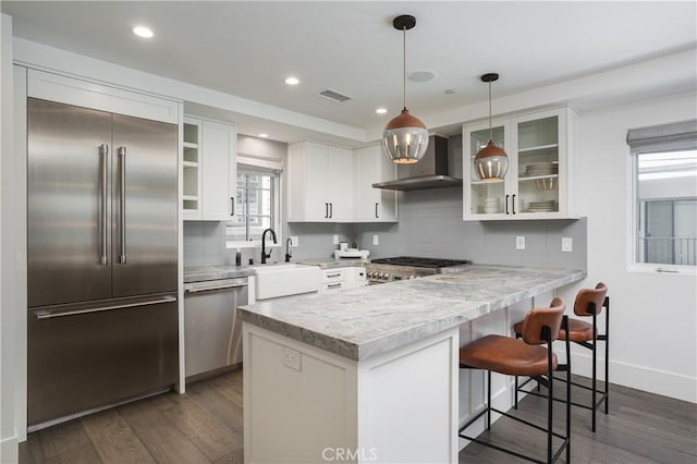 7141/2 Iris Ave, Newport Beach, CA 92625 - kitchen with stainless steel appliances, wall chimney range hood, a peninsula, dark wood-type flooring, and recessed lighting