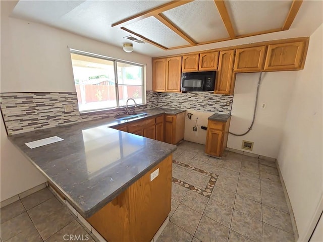 568 Walnut Ct, Kerman, CA 93630 - kitchen with black microwave, a peninsula, backsplash, and light tile patterned floors