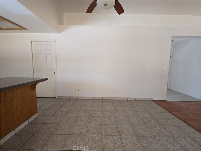 568 Walnut Ct, Kerman, CA 93630 - unfurnished living room with a ceiling fan and dark tile patterned floors