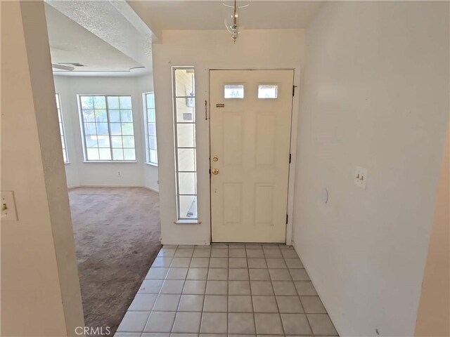 568 Walnut Ct, Kerman, CA 93630 - foyer entrance featuring light carpet and light tile patterned floors