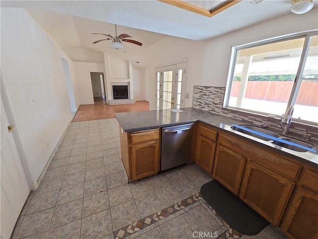 568 Walnut Ct, Kerman, CA 93630 - kitchen featuring dishwasher, light tile patterned floors, tasteful backsplash, ceiling fan, and a peninsula
