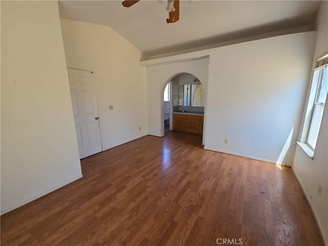 568 Walnut Ct, Kerman, CA 93630 - unfurnished room featuring arched walkways, ceiling fan, wood finished floors, healthy amount of natural light, and lofted ceiling