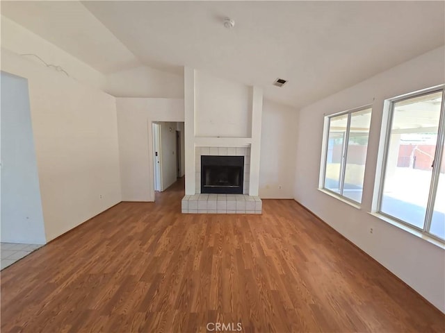 568 Walnut Ct, Kerman, CA 93630 - unfurnished living room featuring wood finished floors, lofted ceiling, and a fireplace