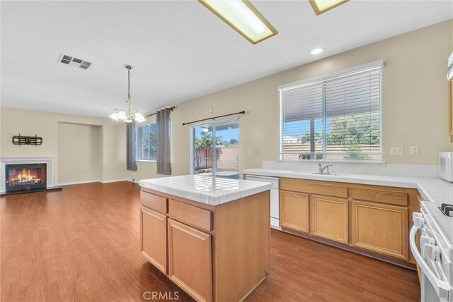 8305 Highridge Pl, Rancho Cucamonga, CA 91730 - kitchen featuring white appliances, a chandelier, tile countertops, wood finished floors, and open floor plan
