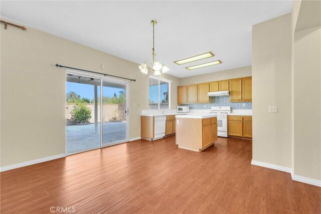 8305 Highridge Pl, Rancho Cucamonga, CA 91730 - kitchen featuring white appliances, under cabinet range hood, a chandelier, light countertops, and wood finished floors