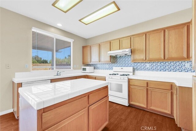 8305 Highridge Pl, Rancho Cucamonga, CA 91730 - kitchen featuring white appliances, under cabinet range hood, dark wood finished floors, recessed lighting, and a kitchen island