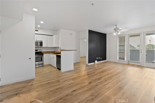 1801 E Katella Ave Unit 1091, Anaheim, CA 92805 - kitchen with appliances with stainless steel finishes, ceiling fan, white cabinetry, recessed lighting, and light wood-style floors