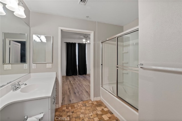 1801 E Katella Ave Unit 1091, Anaheim, CA 92805 - bathroom with stone finish floors, vanity, bath / shower combo with glass door, and a chandelier