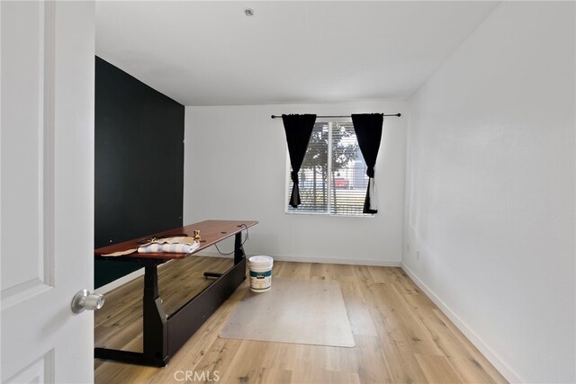 1801 E Katella Ave Unit 1091, Anaheim, CA 92805 - unfurnished bedroom with wood finished floors and baseboards