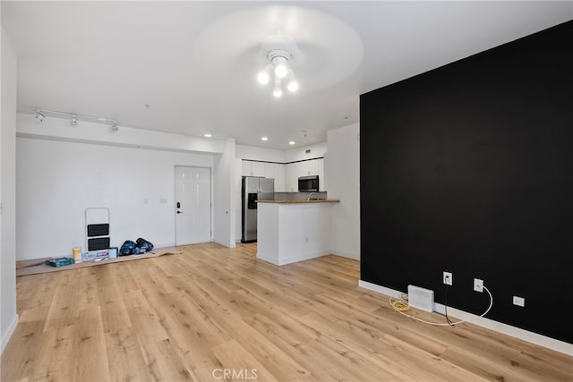 1801 E Katella Ave Unit 1091, Anaheim, CA 92805 - unfurnished living room featuring light wood-style floors and a ceiling fan
