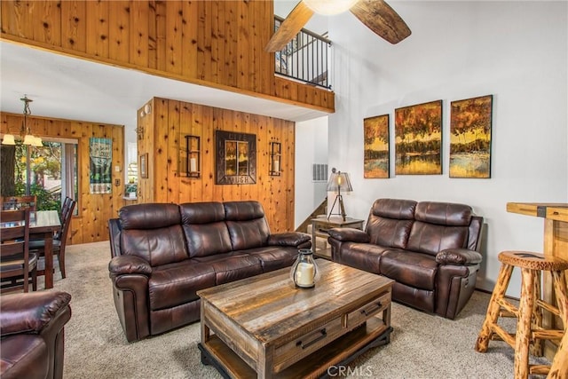 27657 Peninsula Dr, Lake Arrowhead, CA 92352 - living room with wood walls, carpet, a ceiling fan, and a high ceiling