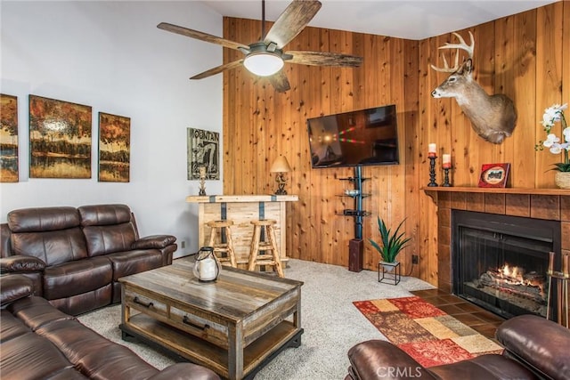 27657 Peninsula Dr, Lake Arrowhead, CA 92352 - living area featuring a fireplace, carpet floors, wood walls, ceiling fan, and a high ceiling