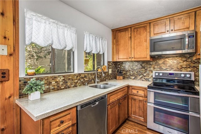27657 Peninsula Dr, Lake Arrowhead, CA 92352 - kitchen with appliances with stainless steel finishes, brown cabinetry, light countertops, decorative backsplash, and light wood-type flooring