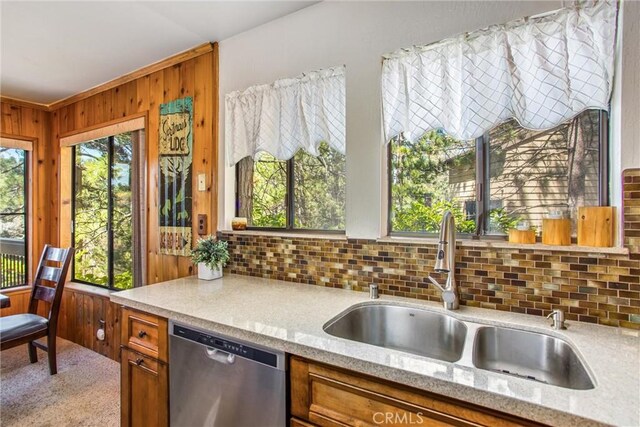 27657 Peninsula Dr, Lake Arrowhead, CA 92352 - kitchen featuring dishwasher, decorative backsplash, wood walls, brown cabinets, and light stone counters