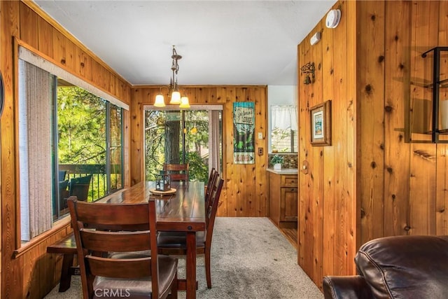 27657 Peninsula Dr, Lake Arrowhead, CA 92352 - carpeted dining area with wood walls and a chandelier