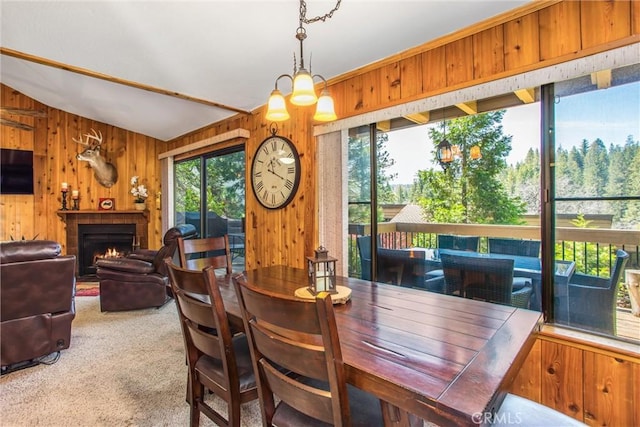 27657 Peninsula Dr, Lake Arrowhead, CA 92352 - carpeted dining room featuring wooden walls and a warm lit fireplace