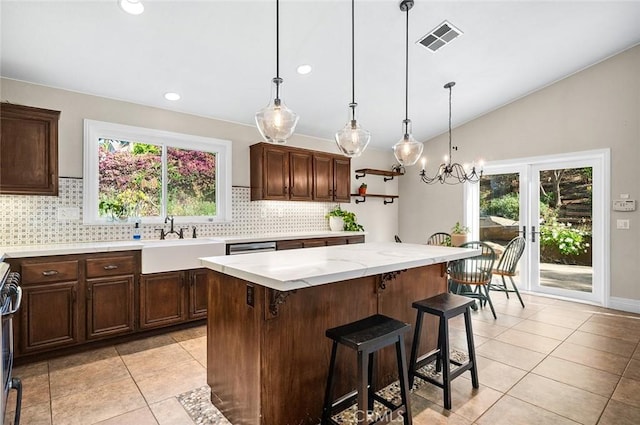 464 Appleby St, Corona, CA 92881 - kitchen with tasteful backsplash, light tile patterned floors, plenty of natural light, a kitchen breakfast bar, and lofted ceiling