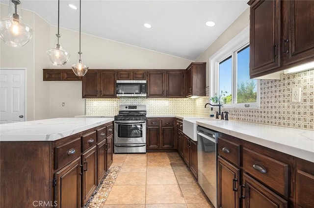 464 Appleby St, Corona, CA 92881 - kitchen featuring stainless steel appliances, lofted ceiling, decorative backsplash, dark brown cabinets, and recessed lighting