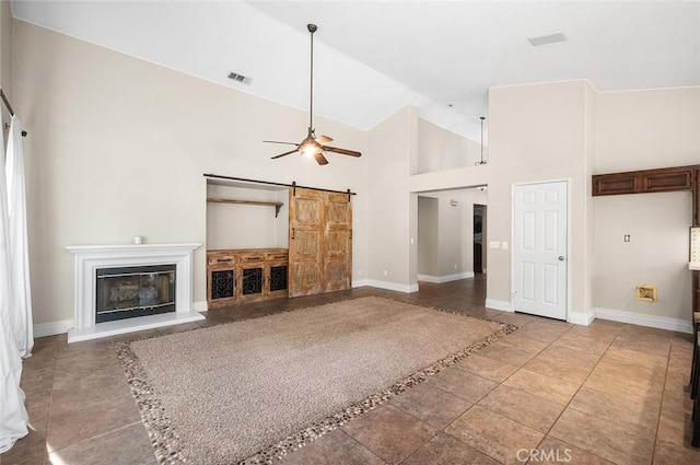 464 Appleby St, Corona, CA 92881 - unfurnished living room featuring a barn door, high vaulted ceiling, ceiling fan, and a glass covered fireplace