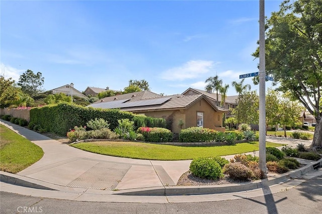 464 Appleby St, Corona, CA 92881 - view of home's exterior with stucco siding, roof mounted solar panels, and a yard