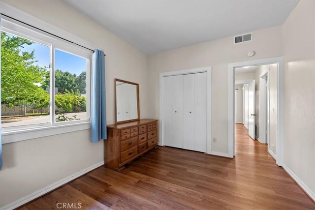 7100 Navajoa Ave, Atascadero, CA 93422 - unfurnished bedroom with wood finished floors, multiple windows, and a closet