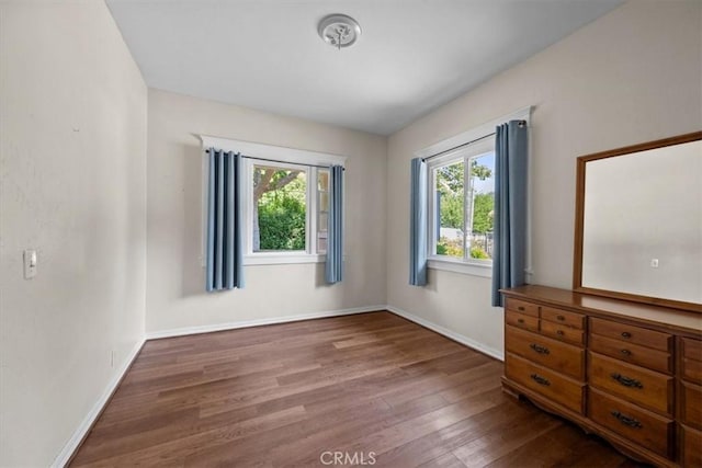 7100 Navajoa Ave, Atascadero, CA 93422 - unfurnished bedroom featuring wood finished floors and multiple windows