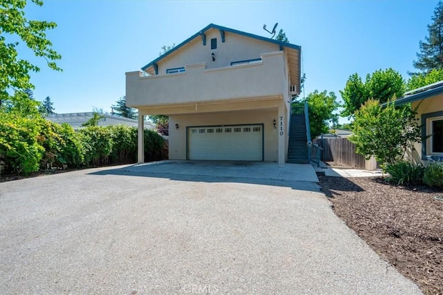 7100 Navajoa Ave, Atascadero, CA 93422 - view of property exterior featuring driveway, a garage, stucco siding, a balcony, and stairs