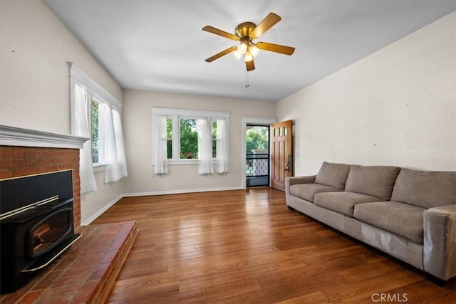 7100 Navajoa Ave, Atascadero, CA 93422 - living room with wood finished floors, a wood stove, healthy amount of natural light, and ceiling fan