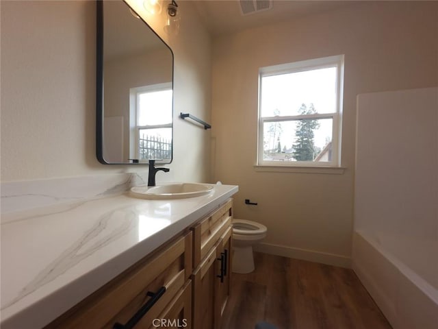 5980 Crestmoor Dr, Paradise, CA 95969 - bathroom featuring vanity, plenty of natural light, wood finished floors, and a bath