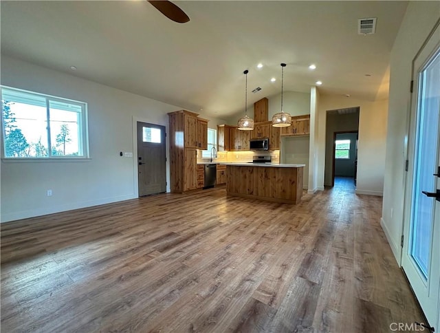 5980 Crestmoor Dr, Paradise, CA 95969 - kitchen featuring stainless steel microwave, open floor plan, dishwashing machine, brown cabinetry, and light countertops