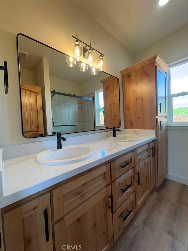 5980 Crestmoor Dr, Paradise, CA 95969 - bathroom featuring double vanity, plenty of natural light, wood finished floors, and an enclosed shower