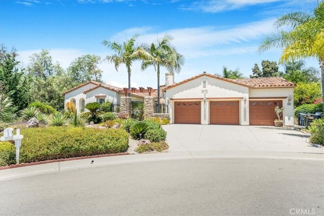 2507 Round Meadow Ct, Fallbrook, CA 92028 - mediterranean / spanish house featuring an attached garage, concrete driveway, stucco siding, and a tiled roof