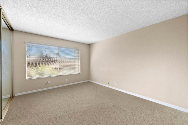 1866 Forestdale Dr, Encinitas, CA 92024 - carpeted empty room featuring baseboards and a textured ceiling