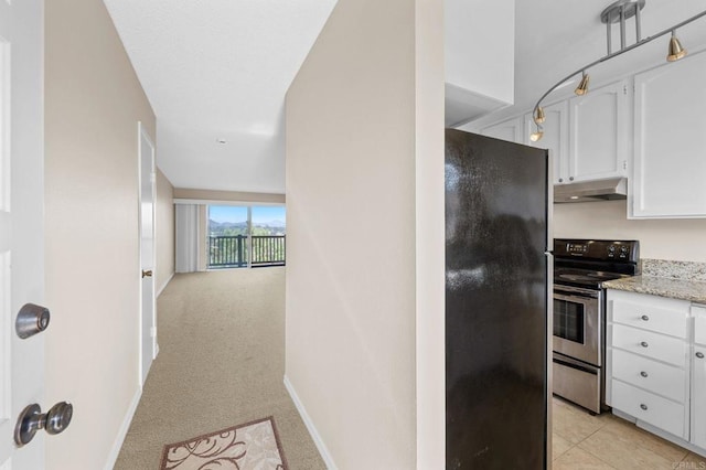 1866 Forestdale Dr, Encinitas, CA 92024 - kitchen with freestanding refrigerator, stainless steel electric range oven, under cabinet range hood, white cabinets, and light carpet