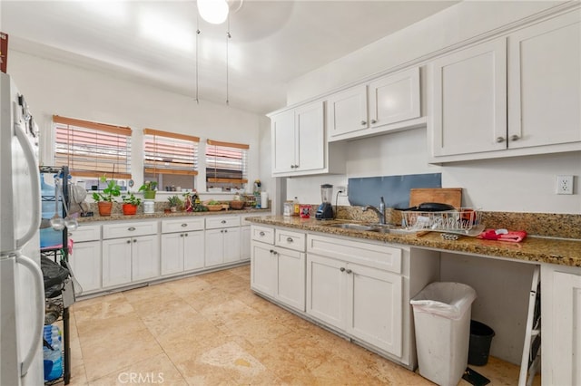 1026 Sentinel Ave, Los Angeles, CA 90063 - kitchen with freestanding refrigerator, white cabinetry, and light stone countertops