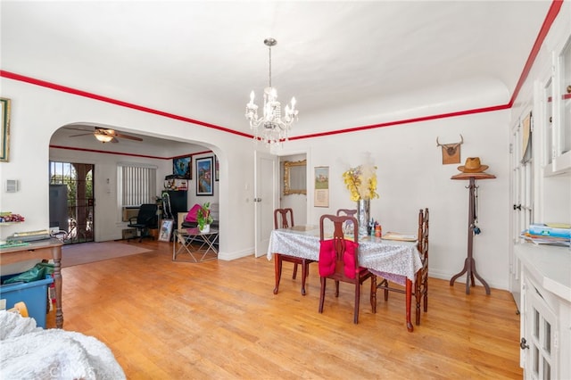 1026 Sentinel Ave, Los Angeles, CA 90063 - dining room featuring arched walkways, light wood finished floors, a chandelier, and ceiling fan