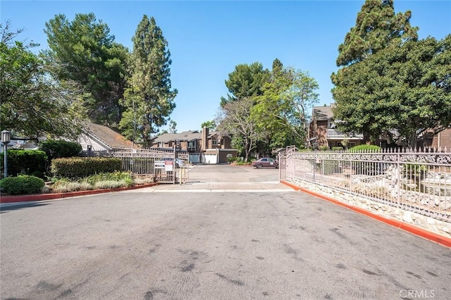 12555 Euclid St Unit 2, Garden Grove, CA 92840 - view of asphalt street featuring curbs, a gated entry, and a residential view