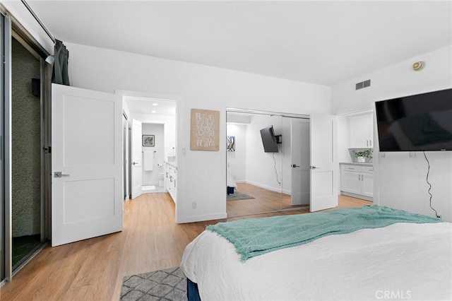 321 S San Vicente Blvd Unit 507, Los Angeles, CA 90048 - bedroom with light wood finished floors, a closet, and connected bathroom