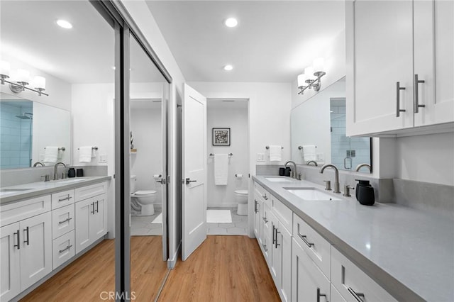 321 S San Vicente Blvd Unit 507, Los Angeles, CA 90048 - full bath featuring wood finished floors, double vanity, and recessed lighting