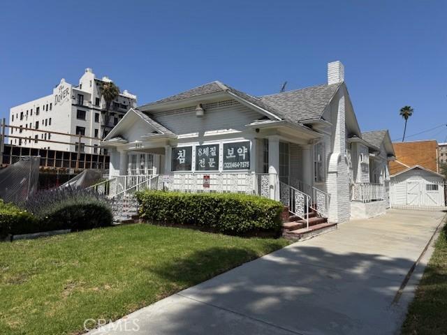 242 N St Andrews Pl, Los Angeles, CA 90004 - bungalow-style house with a front yard, an outbuilding, and a chimney