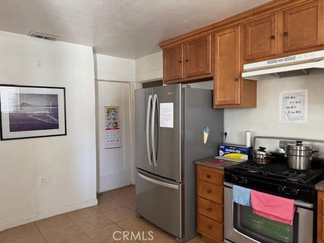 242 N St Andrews Pl, Los Angeles, CA 90004 - kitchen featuring appliances with stainless steel finishes, under cabinet range hood, light tile patterned floors, and brown cabinetry