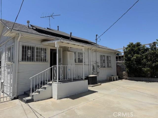 242 N St Andrews Pl, Los Angeles, CA 90004 - back of house with roof mounted solar panels and a patio